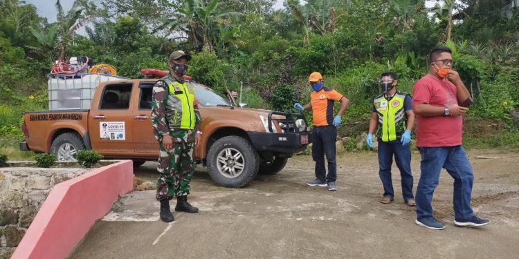 Personel Kodim 0207/Simalungun Melalui Babinsanya Bersama Staf Desa Semprot Cairan Disinfektan Ke Rumah Warga
