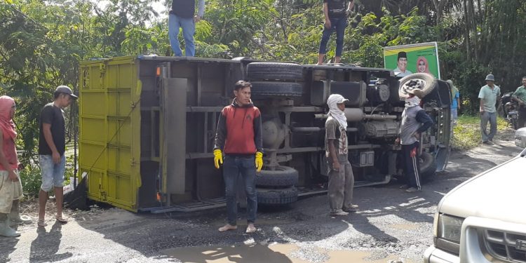 Jalan Rusak dan Sarat Muatan, Truk Pengangkut Pelet Ikan Terbalik
