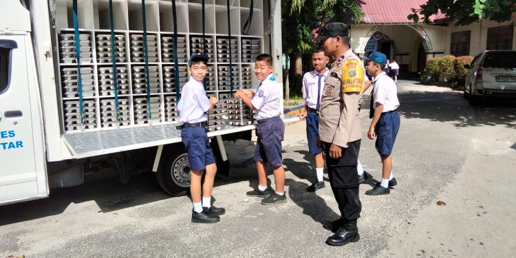 Kawal Distribusi 1.124 Paket MBG, Bhabinkamtibmas Polsek Siantar Timur Turun Langsung ke SMPN 1